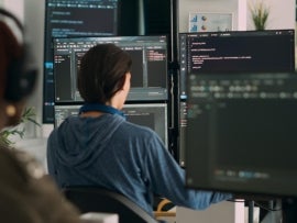 An embedded systems engineer programming on his computer.