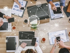 A group of CXOs looking at technology business analysis.