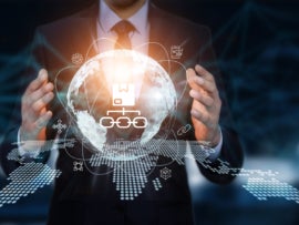 Businessman interacting with a virtual globe with supply chain management icon and a digital map.