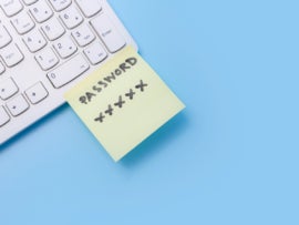 Note paper of password key sticked on keyboard computer.